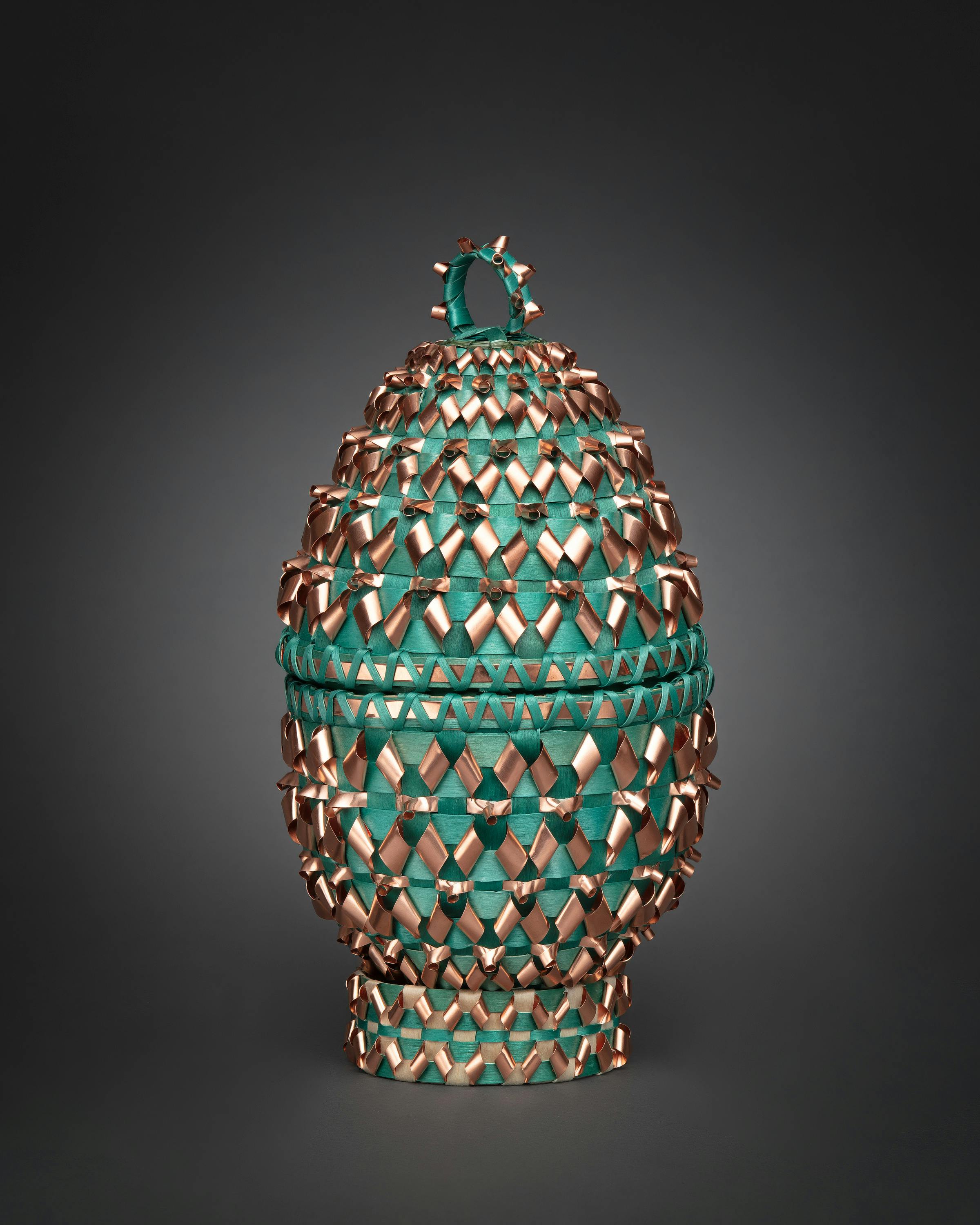 a decorative copper and emerald egg-shaped basket 